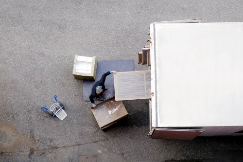 Mover carrying furniture through a local Anerley property
