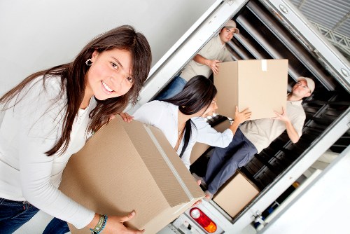 Professional movers loading items for an Anerley relocation