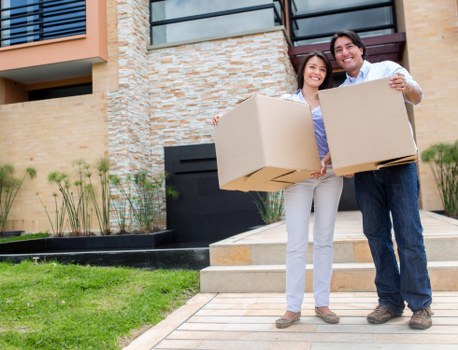 Two movers carrying furniture for an Anerley flat move