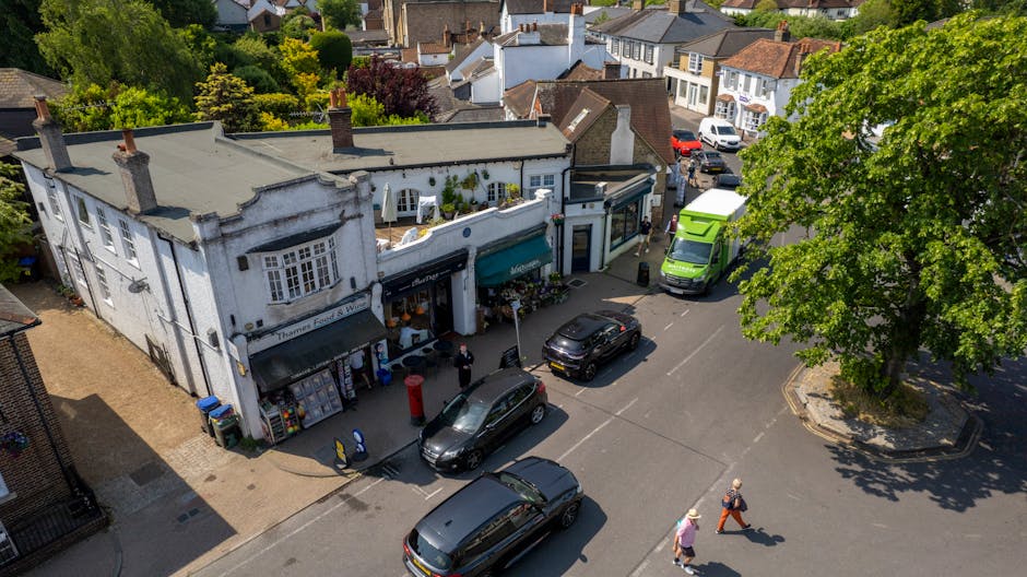 A two-storey brick building located on Penge High Street in Anerley, with a red postal service window and door on the ground floor, and three white-framed windows on the upper floor. The building is a